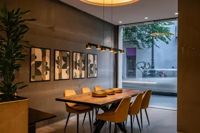 a dining room with a wooden table and chairs at Vincci Mercat in Valencia