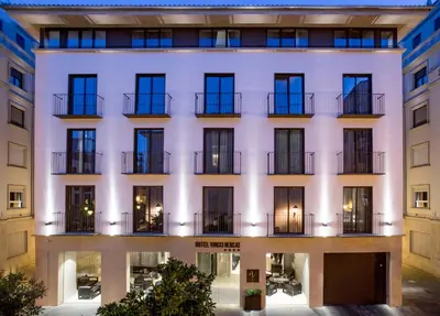 an exterior view of a white building with windows at Vincci Mercat in Valencia