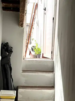 a staircase with a window with potted plants on it at Duplex Loft And Home Office 140m2 plus a 70m2 Terrace in Valencia