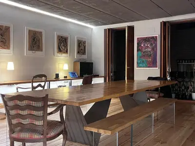 a dining room with a wooden table and chairs at Duplex Loft And Home Office 140m2 plus a 70m2 Terrace in Valencia
