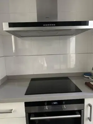 a stove top oven in a kitchen with white walls at Apartamento playa Veramar patacona in Valencia