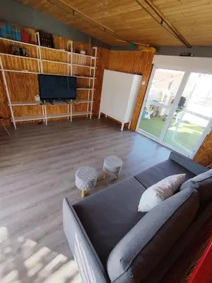 a living room with a couch and a flat screen tv at rural relax Valencia in Villar del Arzobispo
