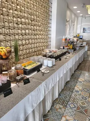a buffet line with food on a table at Hotel Boutique Balandret in Valencia