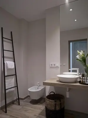 a white bathroom with a sink and a mirror at Hotel Boutique Balandret in Valencia