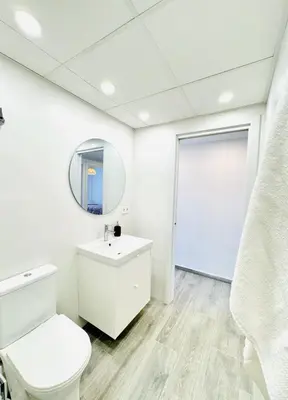 a bathroom with a white toilet and a mirror at NUEVO, a 90 metros de la playa y con vistas al mar in Cullera