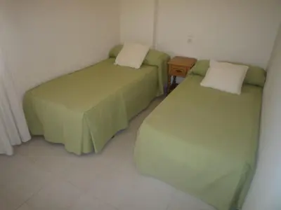 a living room with a couch and a table at Voramar Serviplaya Solo Familias in Casas Las Basas