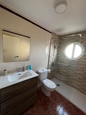 a bathroom with a toilet and a sink at Tu Refugio con Vistas al Mar in Puebla de Farnals