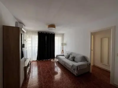 a living room with a couch and a television at Tu Refugio con Vistas al Mar in Puebla de Farnals