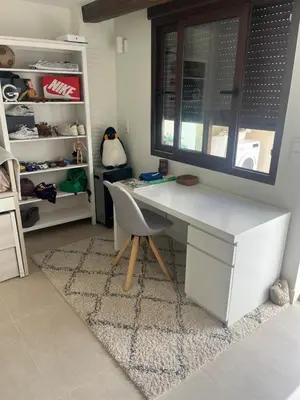 a white desk with a chair in a closet at Ca Erika in Aldaia