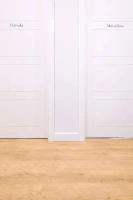 two white doors in a room with wooden floors at L'Esplai Valencia in Valencia