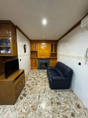 a living room with a blue couch and a tv at Casa Rural Piker in Bolbaite