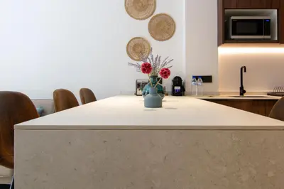 a kitchen with a table with a vase of flowers on it at VLC HOST - Luz Casanova in Valencia