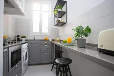 a kitchen with a sink and a washing machine at SingularStays Ca Iconic Living in Valencia