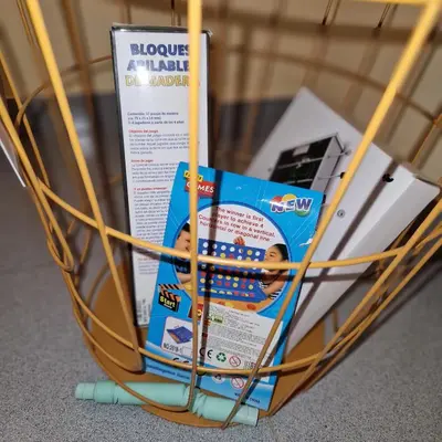 a basket with a book on top of it at Chalet Playa Chilches in Chilches
