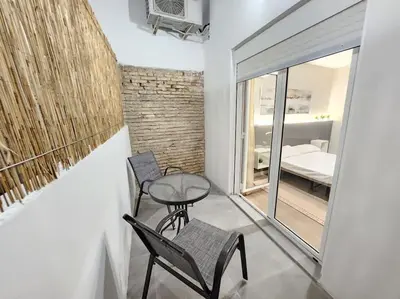 a room with two chairs and a table and a bed at Arquitecto D in Valencia