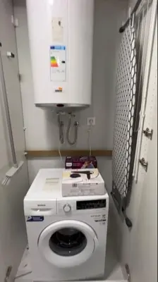 a washing machine in a bathroom with a cabinet at Explore Valencia! Tirant, city of science & Ruzafa in Valencia