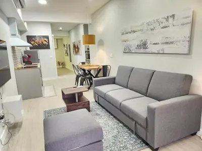 a living room with a couch and a table at Valencia experience! Plus,science city & Ruzafa in Valencia