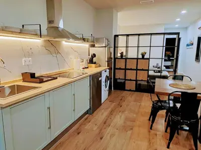a kitchen with a sink and a table with chairs at Artes y ciencias D with fast Wifi and terrace in Valencia