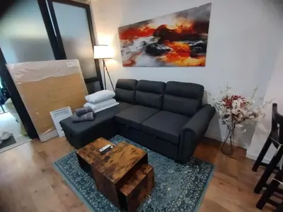 a living room with a black couch and a coffee table at Las Artes y las Ciencias I in Valencia