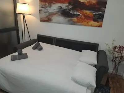a bedroom with a white bed and a painting on the wall at Las Artes y las Ciencias I in Valencia