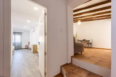 an open hallway leading to a living room with white walls at Las Golondrinas Experiencia Rural in Quesa