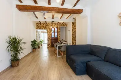 a living room with a blue couch and a table at Las Golondrinas Experiencia Rural in Quesa