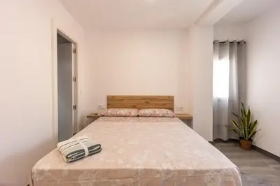 a bedroom with a bed with a purse on it at Las Golondrinas Experiencia Rural in Quesa