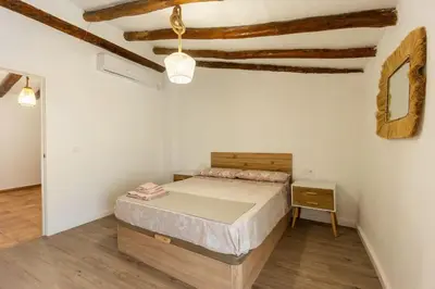 a bedroom with a bed in a room with wooden ceilings at Casa rural las golondrinas in Quesa