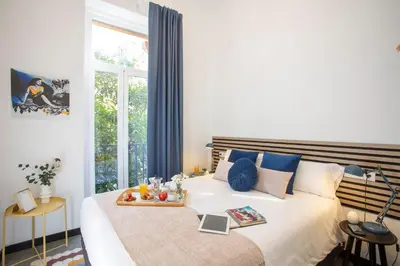 a bedroom with a bed with a tray of food on it at SingularStays Ca Iconic in Valencia