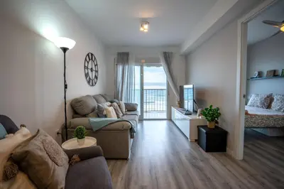 a living room with a couch and a bed at 1ª Linea de Mar 4pax Valencia 15 min in El Perellonet