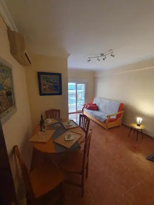 a living room with a table and a couch at Cosy apartment near the beach in Cullera