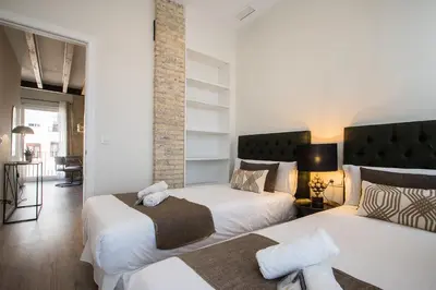 two beds in a room with white walls at MD Jorda Roig Arena in Valencia