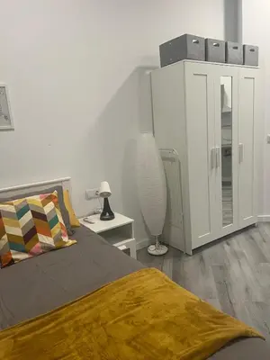 a bedroom with a bed with a yellow blanket on it at Maravilloso Loft - B in Valencia