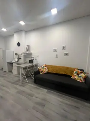 a living room with a bed and a desk and a table at Maravilloso Loft - B in Valencia
