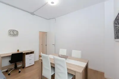 a dining room with a table and chairs and a desk at GuestReady - Lovely flat by Valencia University in Valencia