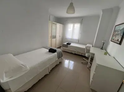 a hotel room with two beds and a couch at Amplio y cómodo apartamento en el centro in Valencia
