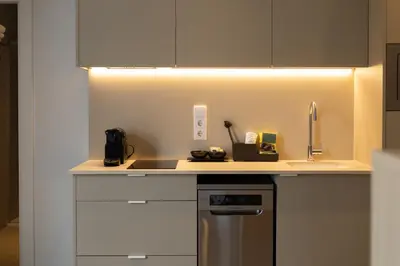 a kitchen with a counter with a sink and a stove at Dorm4You Arena in Valencia