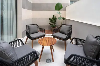 a group of chairs and a table in a patio at Dorm4You Arena in Valencia