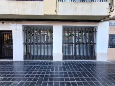 two iron gates on the side of a building at Bonito apartamento de 2 habitaciones cerca de la Estación Joaquín Sorolla in Valencia