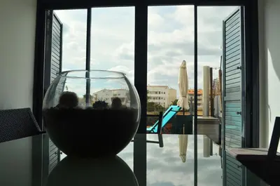 a glass of wine sitting in front of a window at Apartamento a 60 metros de la Playa in Playa de Mar