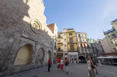 a group of people walking down a city street at SingularStays Plaza Redonda II in Valencia