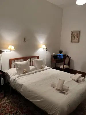 a large white bed with two teddy bears on it at Casa Rural Huerto del Carmen in Puebla Larga