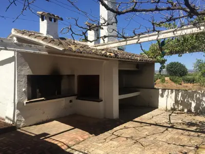 a small white house with a chimney on top at Casa Rural Huerto del Carmen in Puebla Larga