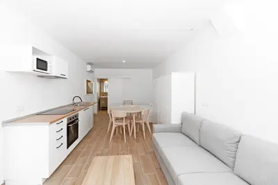 a kitchen and living room with a couch and a table at GuestReady - Retiro agradable en Valencia in Valencia