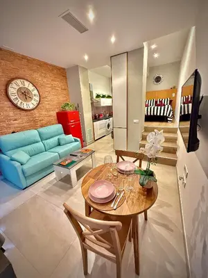 a living room with a blue couch and a table at Céntrico, coqueto y vintage in Valencia
