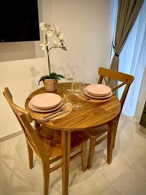 a wooden table with plates and glasses and a plant at Céntrico, coqueto y vintage in Valencia