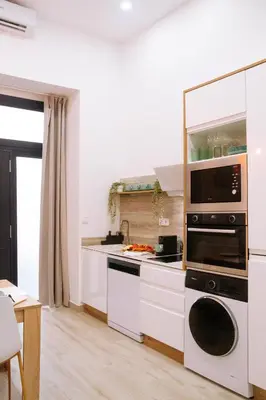 a kitchen with a stove and a microwave at La Brisa Lofts in Valencia