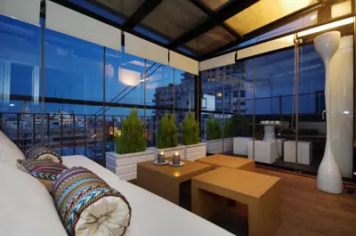 a room with a couch and a table and a large window at Vivaldi Penthouse Ayuntamiento in Valencia
