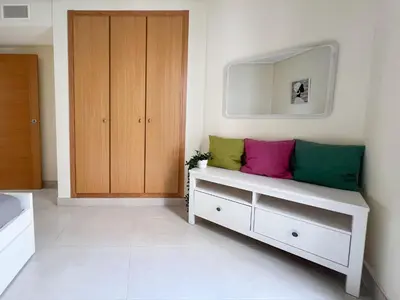 a room with a bench with colorful pillows on it at Non Stress Seven Up in Valencia