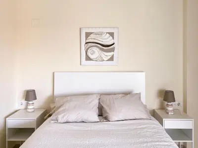 a bedroom with a white bed with two night stands at Non Stress Seven Up in Valencia